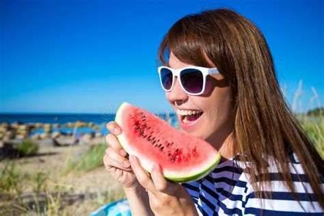 Close Up Portrait Of Beautiful Woman Eating Watermelon On The Beach