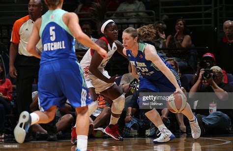 Katie Smith Of The New York Liberty Drives Against Matee Ajavon Of