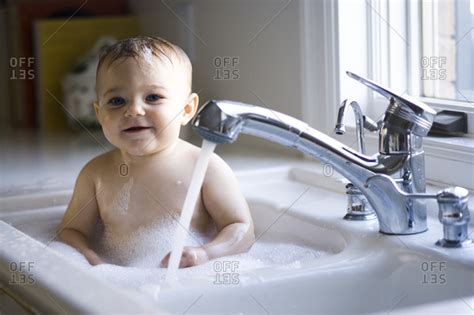 Baby_monkey monkey_shiro #monkey_thibby today our family are go to the village to vintage and little monkey floyd silently sit in basket wait mom bathing don't miss an update from us. Baby bathing in sink - Offset stock photo - OFFSET