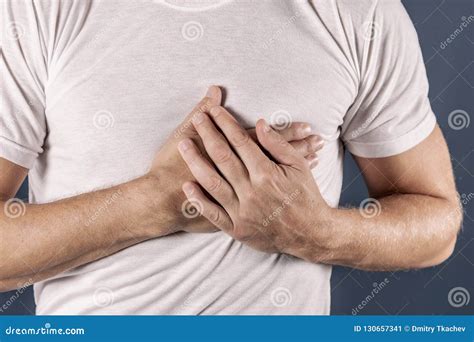 Man Holding His Chest With Both Hands Having Heart Attack Or Painful