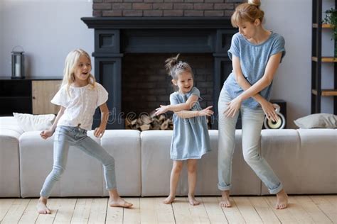 Happy Mother Dancing Having Fun With Two Daughter Stock Photo Image
