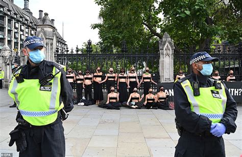 Topless Extinction Rebellion Activists Padlock Themselves To The Gates Of Parliament Daily