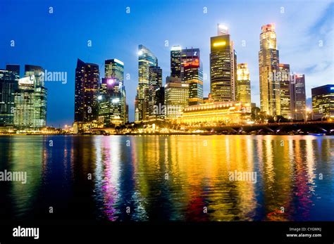 Singapore City Skyline At Night Overlooking Over The Waterfront Of