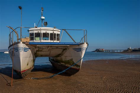 Double Hull Boat With Mumbles Pier In The Background Wales United Kingdom