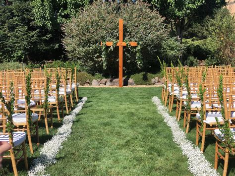 Babys Breath Aisle And A Garland Cross For An All White Wedding