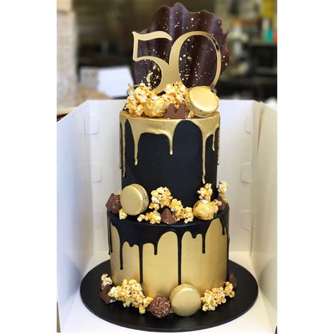Black And Gold Two Tier With Caramel Popcorn Macarons Chocolate Drip