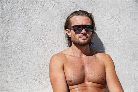 The Handsome Brutal Man In Sunglasses With A Long Hair And Naked Torso