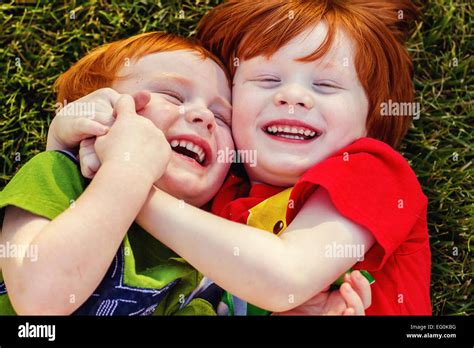 Two Happy Boys Lying On Grass Laughing Stock Photo Alamy