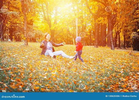 2 Years Old Toddler Have Fun Outdoor In Autumn Yellow Park Stock Photo