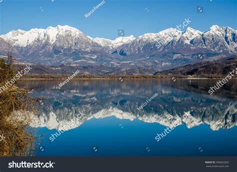 Beautiful View Of A Lake With Snow Capped Mountains Reflected In The