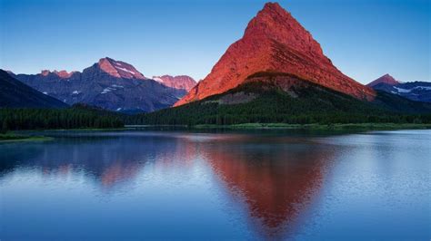 Mount Grinnell View Over Swiftcurrent Lake At Sunrise In Montanas