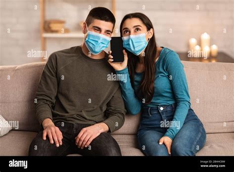 Couple Wearing Surgical Mask Using Cell Phone Stock Photo Alamy