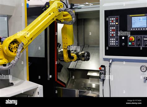 Cnc Lathe Machine And Robot Used For Automation Of Loading And
