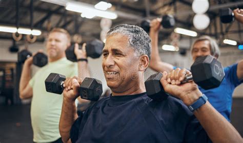 Training Group And Senior Men Exercise Together At The Gym Lifting