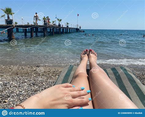 Beautiful Legs Of A Woman With A Pedicure And Manicure On The Hands Of