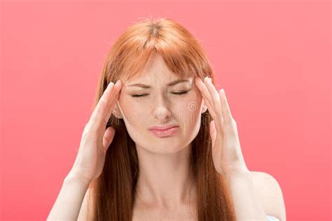 Front View Of Redhead Young Woman With Headache Touching Head Stock