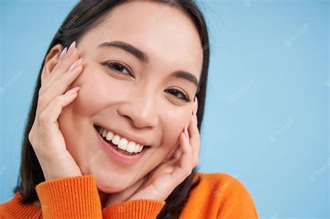 premium photo beauty and skincare close up portrait of happy smiling japanese woman touches