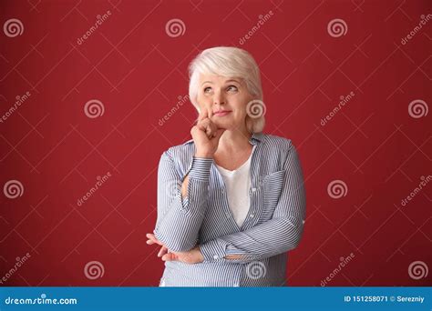 portrait of thoughtful mature woman on color background stock image image of fashion color