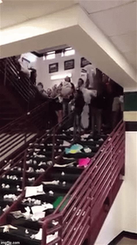 High School Seniors Throw A Waterfall Of Paper Down A Stairway To