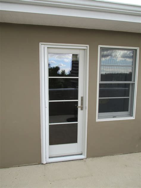 Single White Stowaway Retractable Screen Door With Black Fiberglass