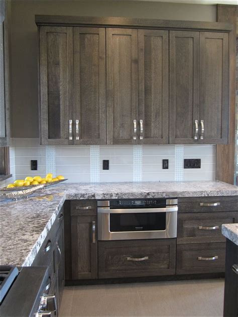 I'm seeing it in perimeter cabinets, in the form of islands, or in simple accents that bring warmth to the kitchen as a whole. Image result for grey stained oak cabinets #kitchencupboarddesignsphotos | Kitchen cabinets ...
