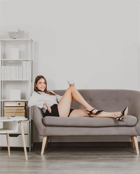 Premium Photo Seductive Secretary With Sexy Legs Sit On Sofa In