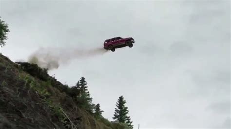 Watch A Bunch Of Beater Cars Go Flying Off A 300 Foot Cliff In Alaska
