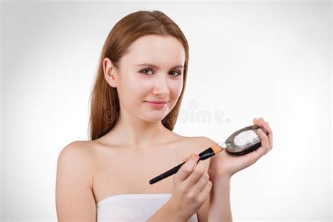 Pretty Girl Putting Facial Cream Or Mask On Young Face Skin With Brush From Jar Stock Image