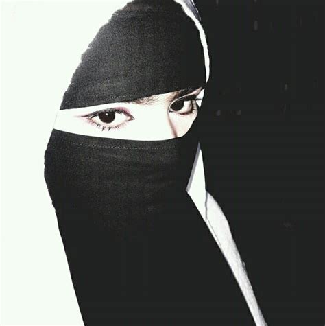 A Woman Wearing A Black Head Covering Over Her Face