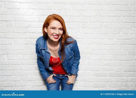 Facial Expressions Of Young Redhead Woman On Brick Wall Stock Photo
