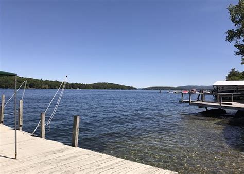 Grand, lakefront home with beach, fire pit and dock. Winnipesaukee Waterfront On Meredith Bay with U Shaped ...