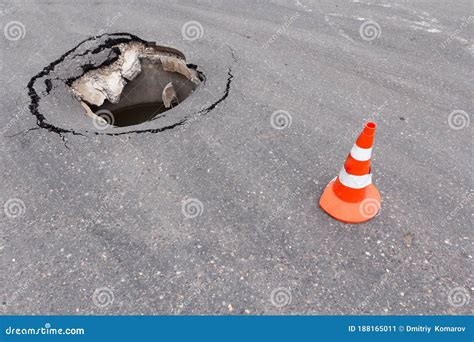 Deep Sinkhole On Street City And Traffic Cone Dangerous Hole In