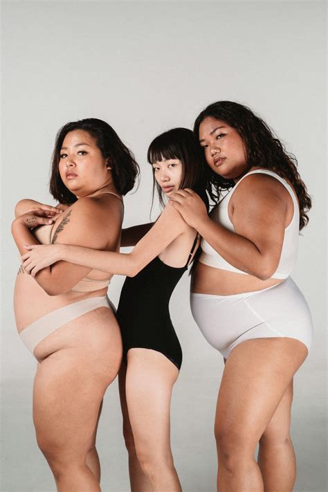 Asian models in underwear cuddling in studio · Free Stock Photo