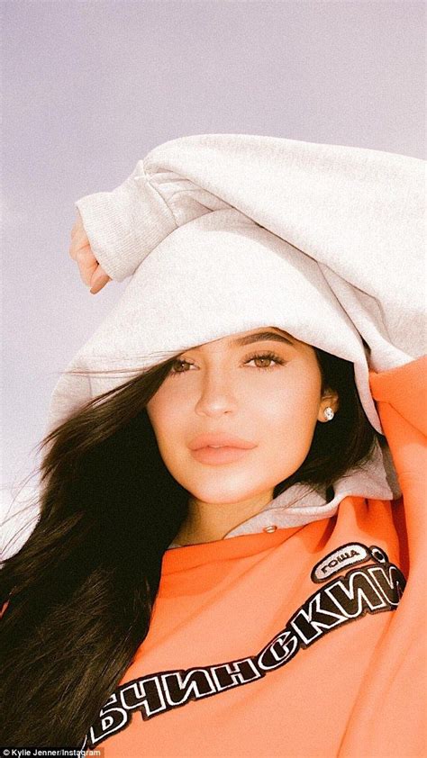 Kylie Jenner Models Orange Sweatshirt In Snow