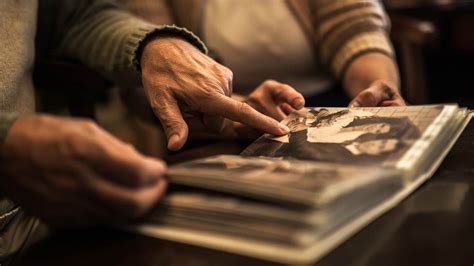Closeup Of Elderly Couple Looking At Photo Album Types Of Memory