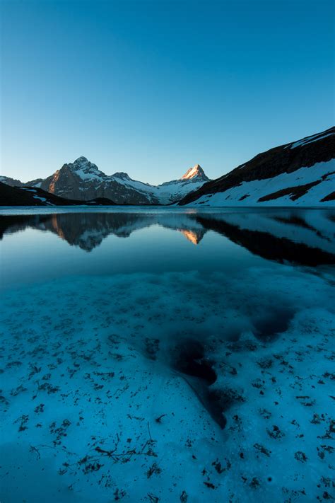 Body Of Water Near Mountain Under Blue Sky During Daytime Landscape