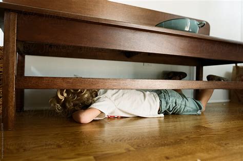 Boy Hides Under Bench In Home Del Colaborador De Stocksy Maria Manco