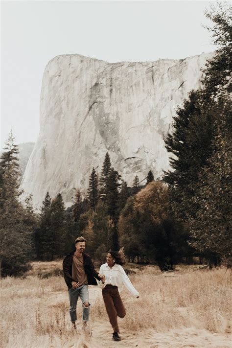 Couple Running Through Yosemite National Park In Front Of El Capitan