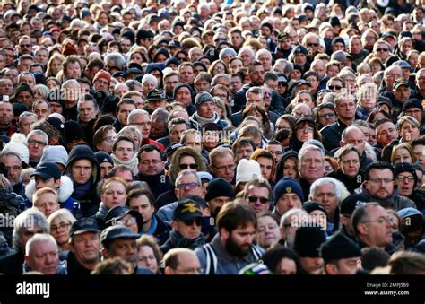 The crowd stands outside La Madeleine church for French rock star