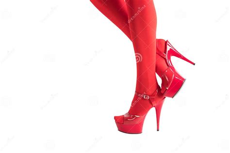 Female Legs In Fetish Red Stockings And Red High Heels On White Christmas And New Year Concept