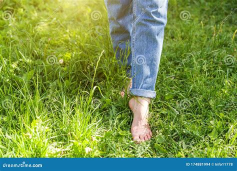 Two Beautiful Female Feet Walking On Grass In Sunny Summer Morning