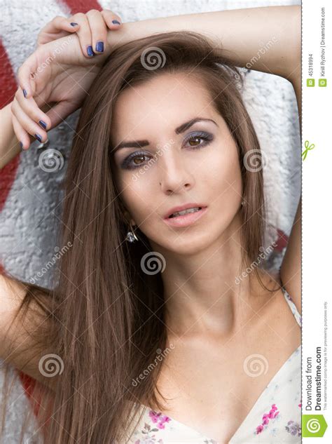 Portrait Of Sexy Slim Brunette Woman Leaning Against Wall