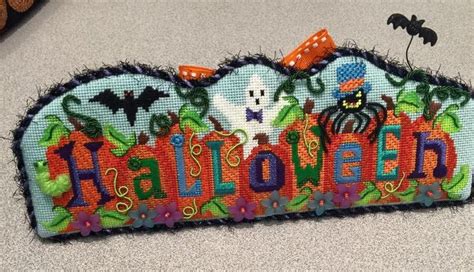 This Is An Embroidered Sign That Says Halloween