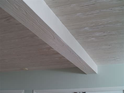 The vaulted ceiling of this room is paneled in wood, and features faux wood beams in a glossy white. Ceiling #2: White faux beam | Faux wood beams, Wood beams ...