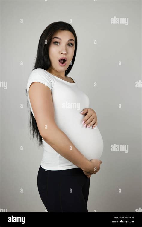 Beautiful Pregnant Brunette Woman Holding Her Pregnant Belly With