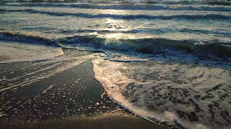 Sea Waves Rolling On Sandy Shore Beach On Sea Coast Dawn Sunset Blue