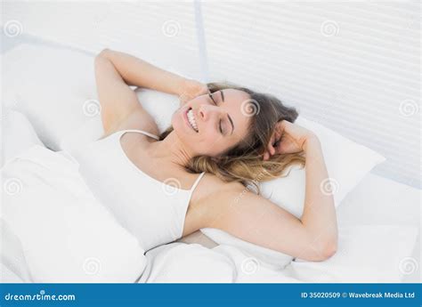 Lovely Exhausted Woman Lying On Her Bed Stretching Out Stock Image