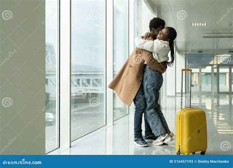 African Man And Woman Hugging In Airport Male Giving Female Warm Welcome Embrace After Travel