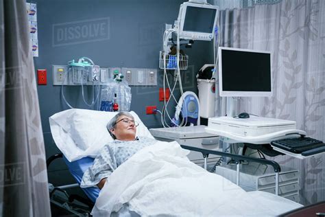 Mixed Race Patient In Hospital Bed Stock Photo Dissolve