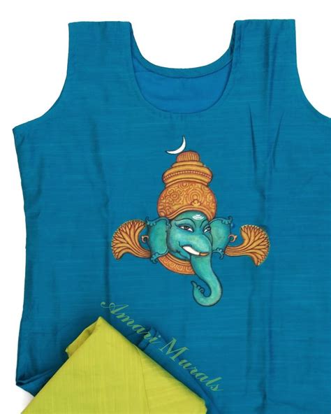 A Blue Shirt With An Elephant On It And A Yellow Napkin Next To The Top